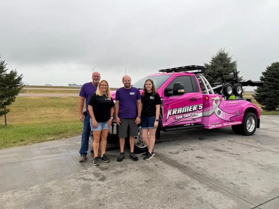 The Kramer's Wrecker family in front of the pink wrecker