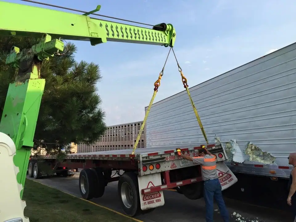 Rotator lifting a damaged trailer