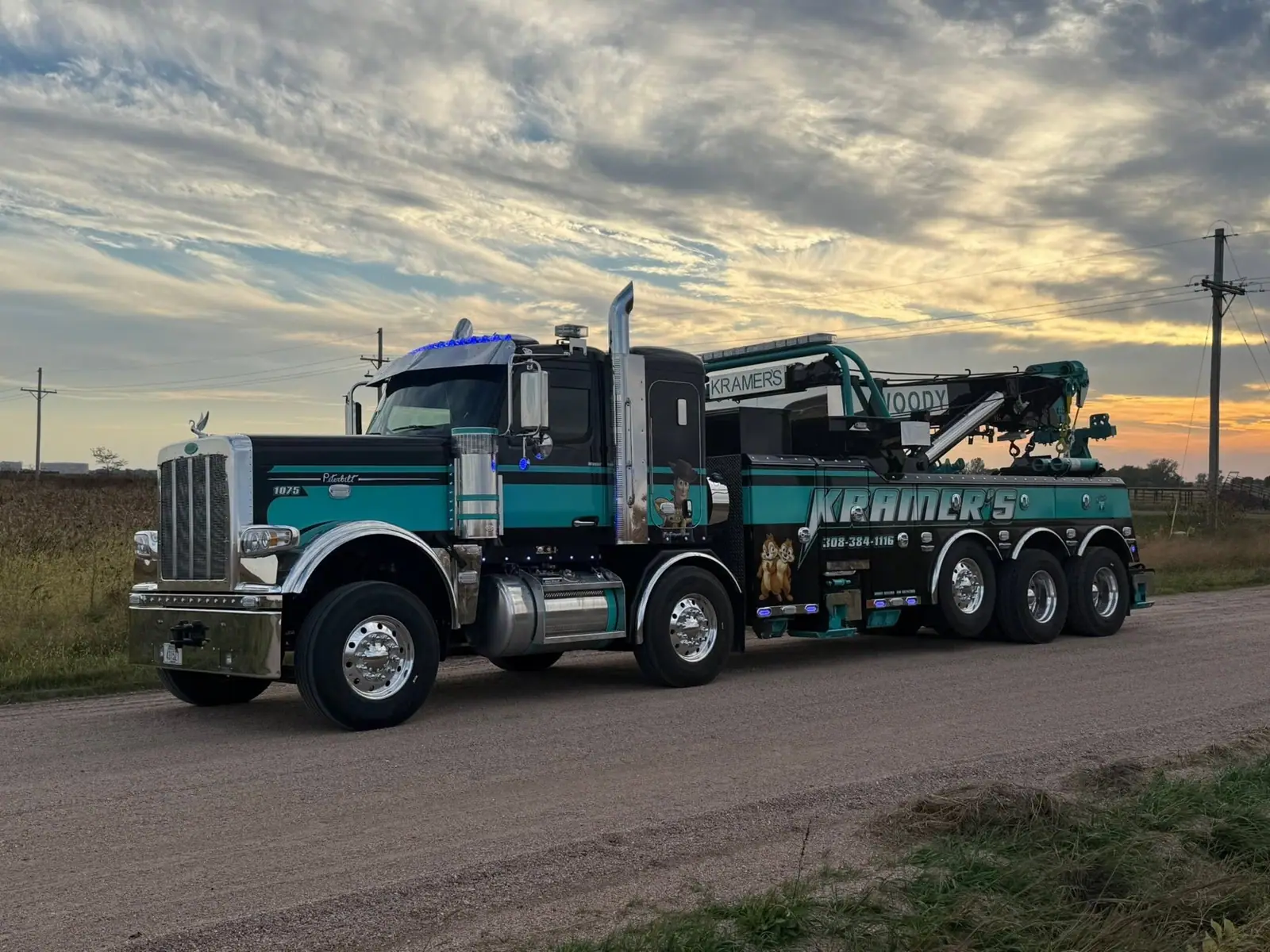 Kramer's teal heavy-duty wrecker at sunset